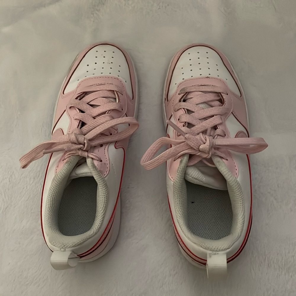 Pink and white Nike shoes